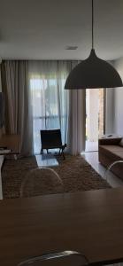 sala de estar con sofá y lámpara colgante grande en Residencial Iloa, en Barra de São Miguel