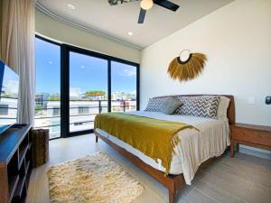 a bedroom with a bed and a large window at Beautiful + Luxury + Ocean View + Pool in Playa del Carmen +47 photos