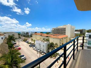 a balcony with a view of a street and buildings at Beautiful + Luxury + Ocean View + Pool in Playa del Carmen
