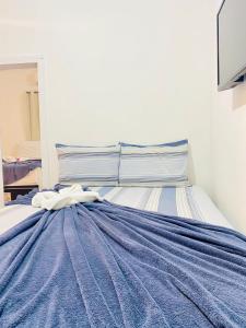 Łóżko lub łóżka w pokoju w obiekcie Pousada Center