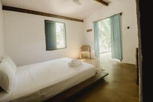Cama ou camas em um quarto em Pousada Peixe do Mato