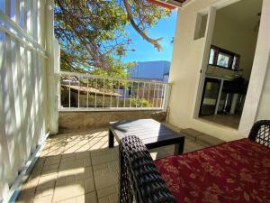 a porch with a couch and a table on a balcony at Adorable Private Studio in Tijuana