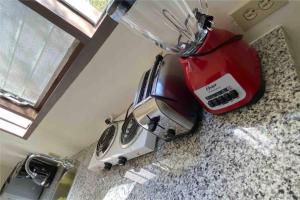 a red blender sitting on top of a counter at Adorable Private Studio in Tijuana