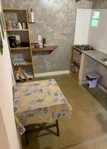 a kitchen with a table and a chair in a kitchen at CASA MAR DE FORA in Fernando de Noronha +29 photos