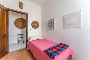 a bedroom with a pink bed and a mirror at Attico Montiglio - by Host4U in Brescia