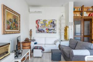 a living room with a couch and a tv at Attico Montiglio - by Host4U in Brescia