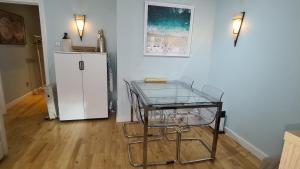 a room with a glass table and a refrigerator at Impressive Apartment at Leeds City Centre in Leeds