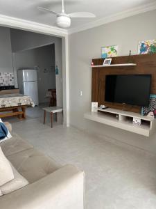sala de estar con sofá y TV de pantalla plana en Casa da Penha/SC, en Penha
