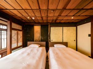 Letto o letti in una camera di NIPPONIA Chichibu Monzenmachi