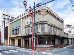 un vecchio edificio all'angolo di una strada di NIPPONIA Chichibu Monzenmachi a Chichibu