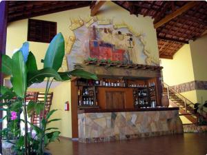 a bar in a building with a stone wall at Canto de Itamambuca in Ubatuba