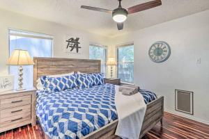 a bedroom with a bed and a clock on the wall at NEW! ATX Home with 3 Patios, 3 TVs, & Fire Pit in Austin