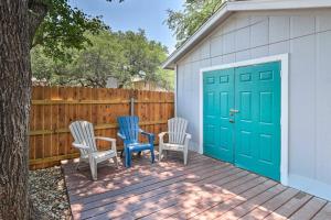 a group of three chairs sitting on a deck with a garage at NEW! ATX Home with 3 Patios, 3 TVs, & Fire Pit in Austin