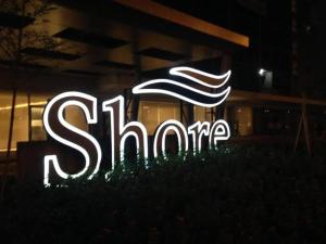 a lit up sign in front of a building at SHORE RESIDENCE D7 NEAR MALL OF ASIA & AIRPORT in Manila