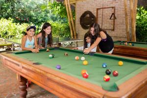 a group of women playing a game of pool at El Campito Lodge in Ayampe