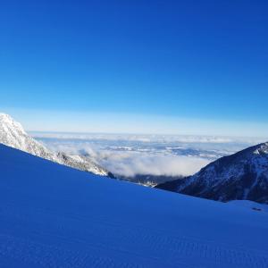 a view of a snowy mountain with clouds in the background at Ferienhaus Carmen in Grän