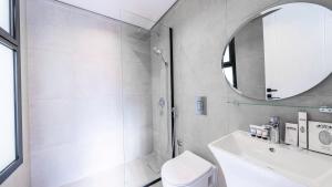 a bathroom with a toilet and a sink and a mirror at Mabaat-Superior 2BR-Al Aqiq 399 in Riyadh +7 photos