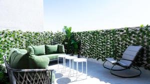 a patio with a couch and chairs and a fence at Mabaat - Al Aqiq - 399 in Riyadh