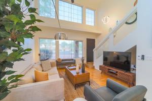 a living room with couches and a flat screen tv at Westworld, TPC Golf, Hiking in Your Backyard! in Scottsdale