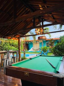 a pool table sitting under awning with a pool table at HOTEL CAREY in Pedasí Town