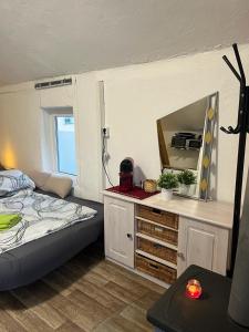 a bedroom with a bed and a mirror on a dresser at Monteurzimmer bei EnergyFreund in Knetzgau