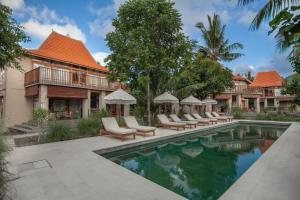 an exterior view of a resort with a swimming pool at Diamond Beach Villas in Nusa Penida