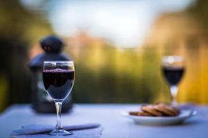 two glasses of red wine sitting on a table at Hotel Sintra Jardim in Sintra