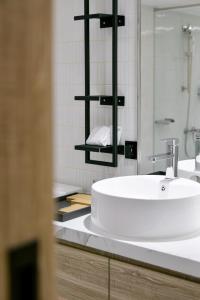 uma casa de banho com um lavatório branco e um espelho. em Spring Rhapsody Hotel em Taichung