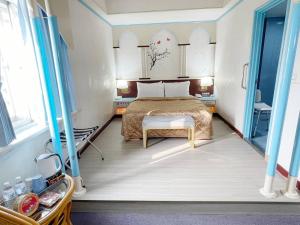 a bedroom with a bed and a table in it at Hua Ku Hotel in Tainan
