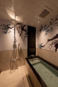 a bathroom with a shower and a bath tub at HOTELみなと-MINATO- in Tokyo