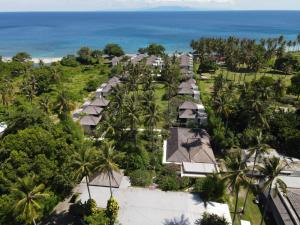 an overhead view of a resort with palm trees and the ocean at Living Asia Resort and Spa in Senggigi