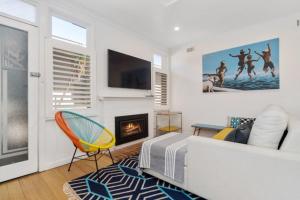 a living room with a bed and a fireplace at On The Beach in Rosebud