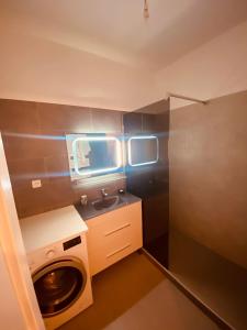 a small bathroom with a washing machine and a sink at Monaco border villa Maria in Beausoleil