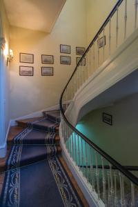 a spiral staircase in a home with green walls at Hotel Sintra Jardim in Sintra