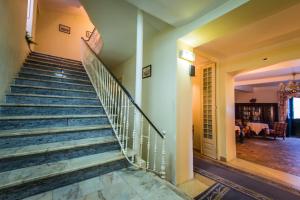 a staircase in a house with a living room at Hotel Sintra Jardim in Sintra