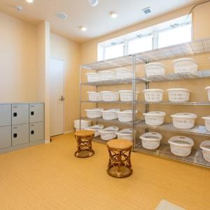 a room with shelves filled with white dishes at Ogal Inn in Yahaba