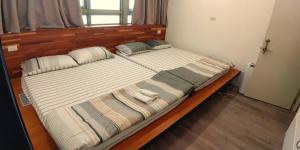 a large bed in a bedroom with two pillows at Mudan Gathering Homestay in Shuangxi