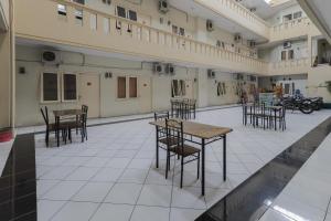 an empty room with tables and chairs in a building at Koolkost @ Siwalankerto in Surabaya