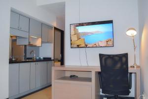 a kitchen with a desk and a black chair at Lemansion Senopati in Jakarta