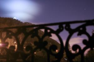 a wrought iron fence with the moon in the background at Hotel Sintra Jardim in Sintra