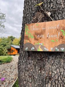 a sign on a tree with a sign on it at MoodySun Studio, remote tiny home in Comarnic