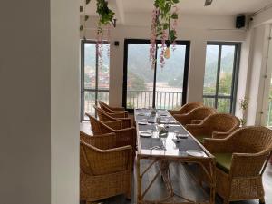 瑞诗凯诗Hotel Shiva Yog Sthal的有一张长桌子和椅子的餐厅