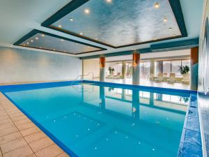 a large swimming pool with a large ceiling at Apartment in Lienz with a balcony in Obernussdorf