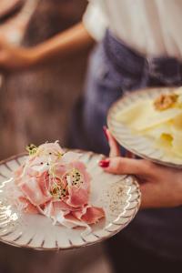 a person holding a plate with a flower on it at Kai 36 - Hotel zwischen Fels und Fluss in Graz