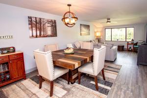 a dining room and living room with a wooden table and chairs at Golf & Tennis Community - Lakeview Oasis in Wesley Chapel