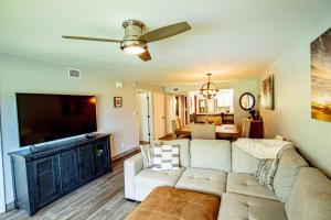 a living room with a couch and a flat screen tv at Golf and Tennis Community-Lakeview Oasis-Private Patio in Wesley Chapel