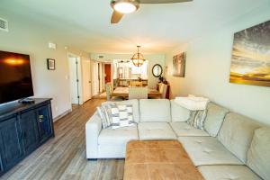 a living room with a white couch and a table at Golf & Tennis Community - Lakeview Oasis in Wesley Chapel
