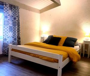 a bedroom with a bed with a yellow blanket at Domaine des fées in La Gaubretière +127 photos