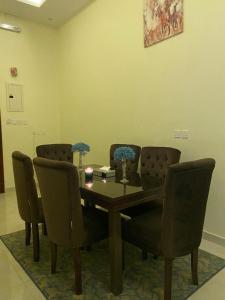 a dining room with a table and chairs at القصر المطار in Abha