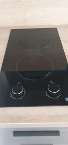 a stove top with two rings on top of it at Charmant logement neuf in Hourtin